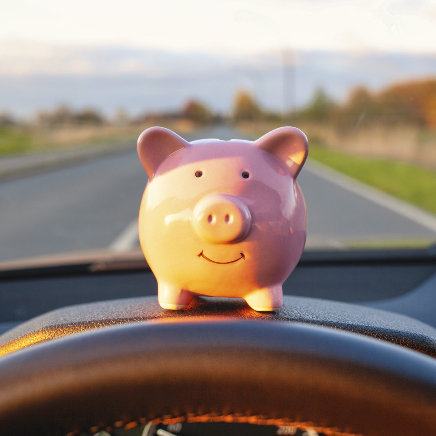 Money pig sitting on dashboard