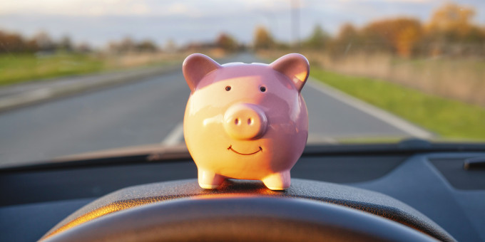 Money pig sitting on dashboard