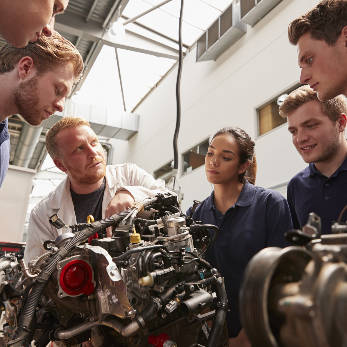 Group of interns working on engine