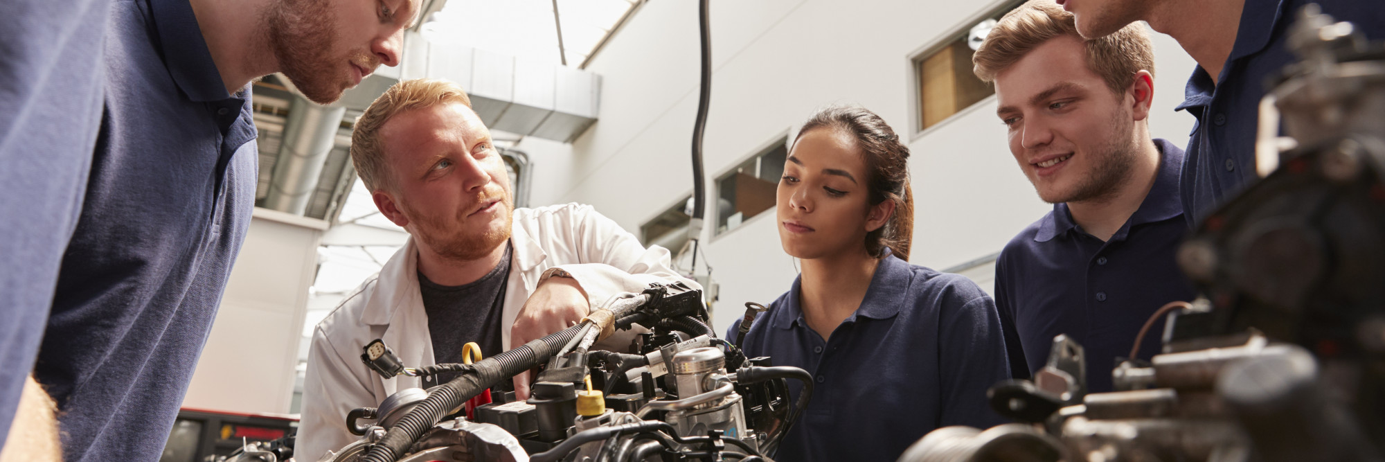 Group of interns working on engine