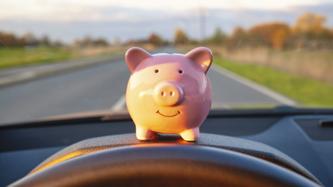 Money pig sitting on dashboard