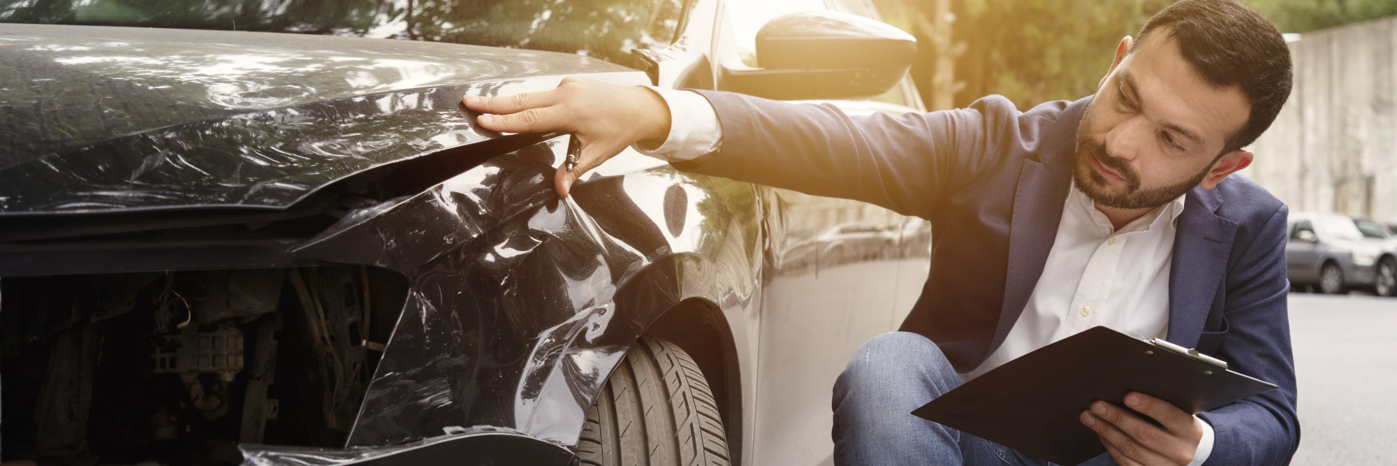 Man examining car crash 1