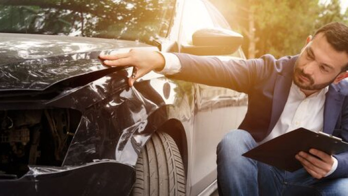 Small Man examining car crash 3